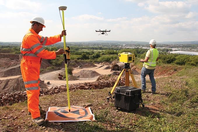 Survey team using RTK equipment and drone support on site